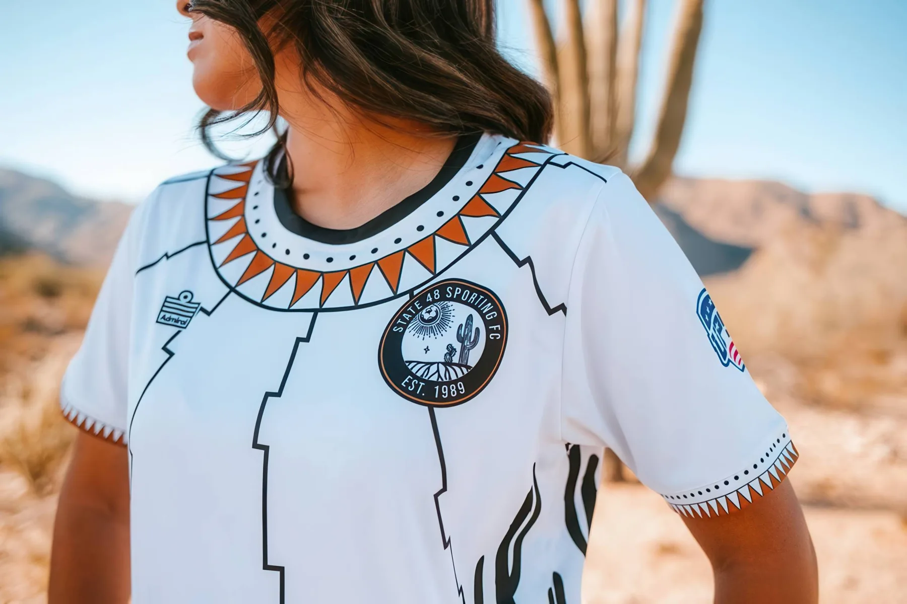 Detail of the State 48 home jersey collar, crest and illustrated saguaro design